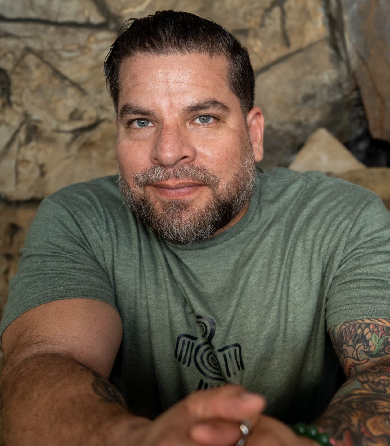 Chef Darwin Santa Maria wearing a green Darwin Brewing T-shirt.